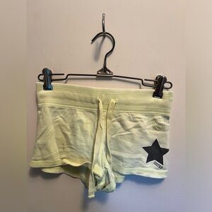 Justice, girls youth yellow shorts with black details and lettering on back.